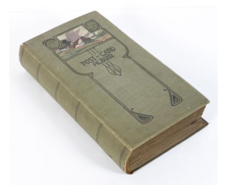 An Art Nouveau postcard album mounted with early 20th century worldwide postcards