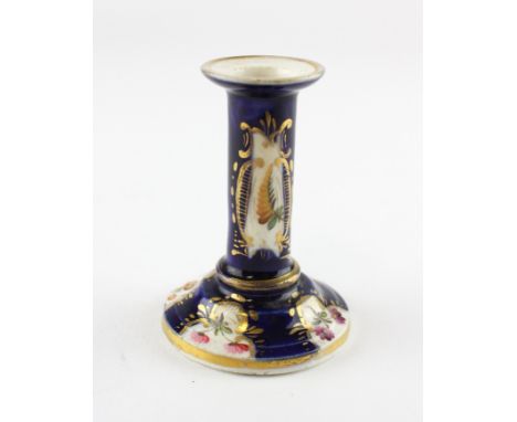 An English porcelain blue-ground chamber candlestick, circa 1820, probably Derby or Coalport, painted with flower-sprays with