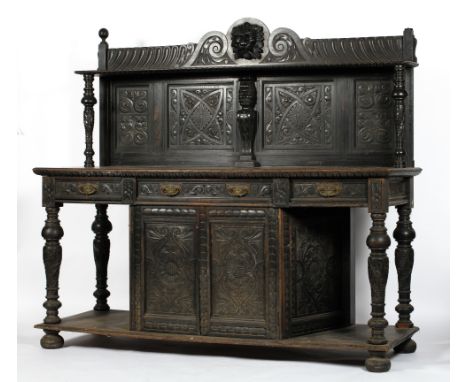 A 19th century oak buffet, the scrolling gallery above a single shelf and four carved panels, the base with three drawers and