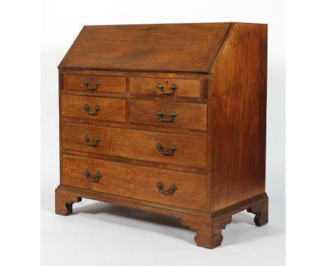 A George III-style mahogany bureau, the fall front enclosing a cupboard, drawers and pigeon holes, with four graduated short 