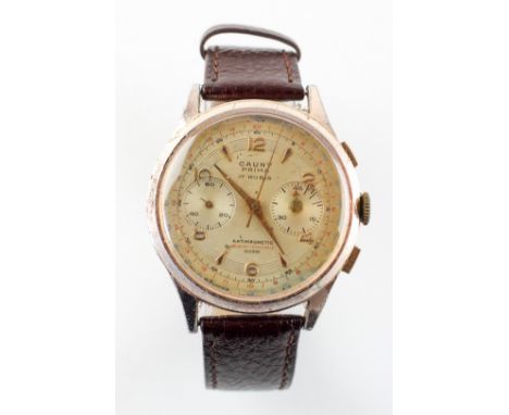 A gold plated Cauny Prima wristwatch. 17 Jewel (Rubis) manual wind movement. Chronograph feature. Brown leather strap. 39.1 g