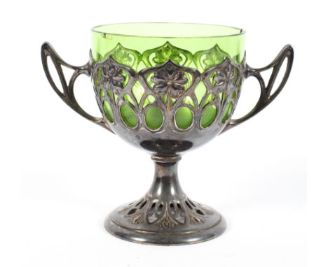 An EPNS mounted green glass Art nouveau goblet, pierced with stylised flowers, with whiplash handles, circa 1900, 13.5 cm hig