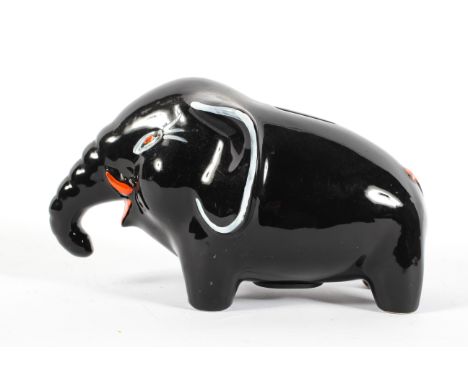 An Italian pottery elephant money-box, mid-century, enriched in a black glaze with features picked out in orange and white en