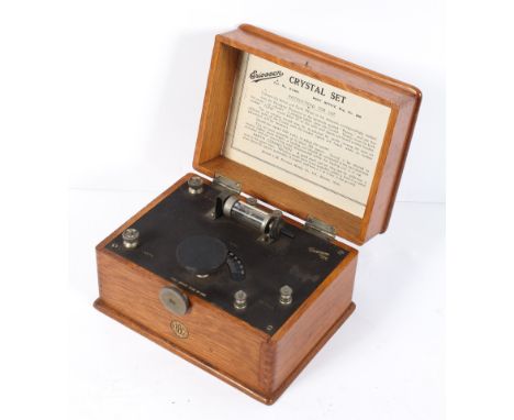 An Ericsson crystal set, with sweep tuning dial and detector, in hinged oak case, bearing BBC and instructions for use labels
