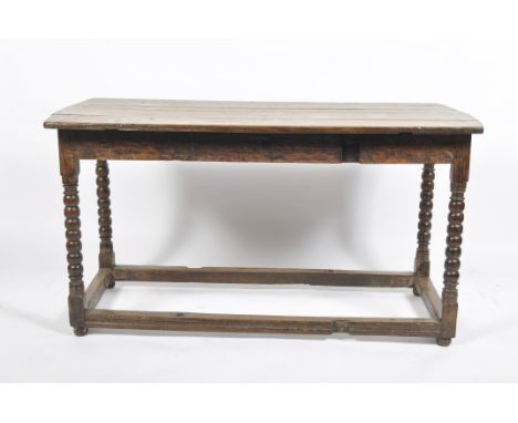 An oak table, 18th century and later, the planked top bobbin turned legs and block stretchers, formerly a gateleg table, 69cm