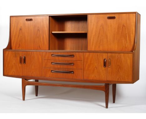 A G-Plan Fresco 1960s teak sideboard, with one sliding cupboard door and another fall front door flanking a central shelf, ab