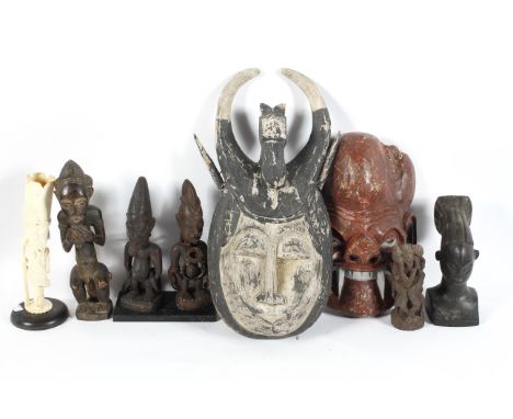 A collection of tribal art, including: two carved and painted theatrical masks, 52 cm long maximum, various African anthromor