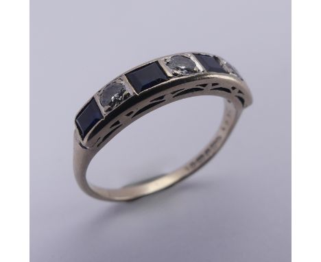 A sapphire and diamond half hoop Eternity Ring, channel set with four calibre cut sapphires and three brilliant cut diamonds,