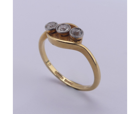 A three stone diamond Ring,&nbsp;the old cut stones millegrain set in 18ct yellow gold and platinum, approx. total diamond we