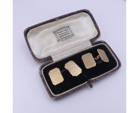 A cased pair of 9ct gold Cufflinks, of rectangular form with canted corners and engine turned decoration, approx. total weigh