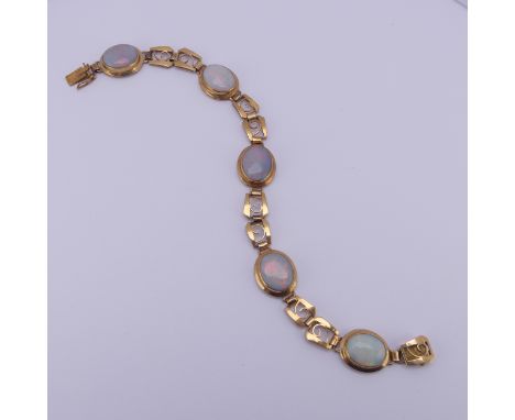 An 18ct yellow gold and opal Bracelet,&nbsp;with five oval cabochon opals each approx. 12mm long, collet set in oval mount, w