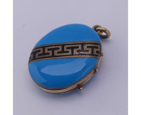A Victorian oval hinged Locket, the front and reverse with turquoise blue enamel and a band of black and gold Greek Key decor