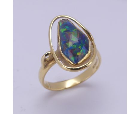 An abstract opal Ring, collet set in 18ct yellow gold, Size Q, 5.8g. 