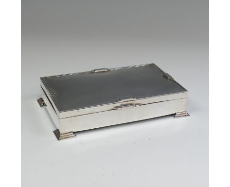 A George V silver Cigarette Box, hallmarked Birmingham 1931, makers mark rubbed, in the Art Deco style with stepped feet and 