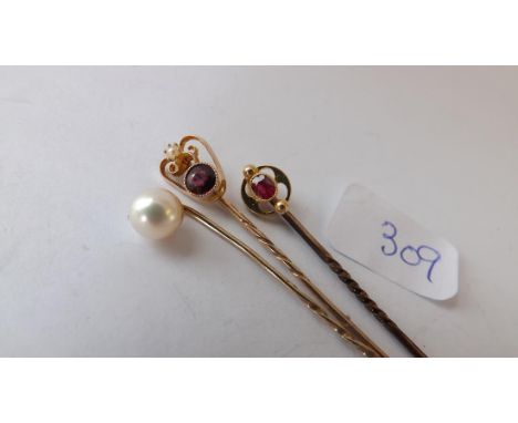 Three gold stone set stick pins     