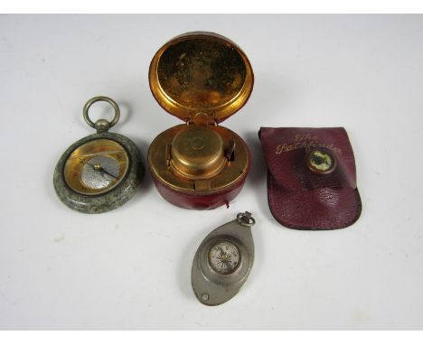 A portable ink well, together with a pathfinder compass and one other similar