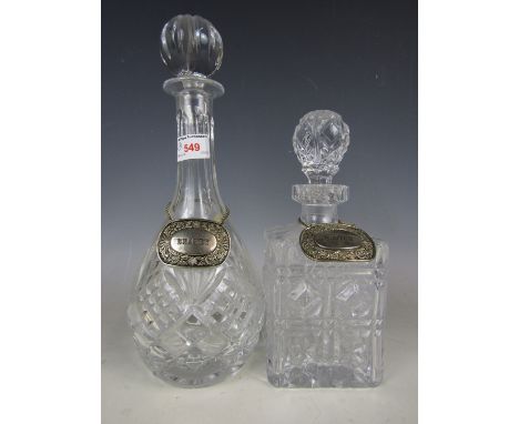 A Royal Albert decanter together with one other decanter and two electroplate bottle tickets