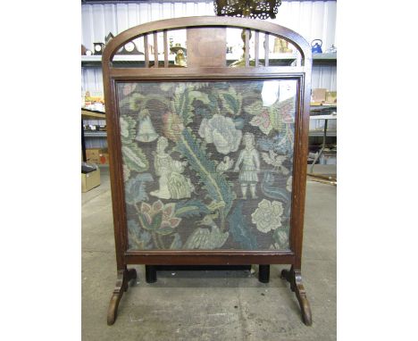 An early 20th century mahogany fire screen with tapestry insert