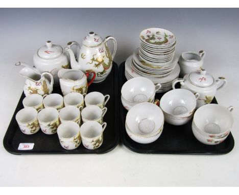 A Japanese eggshell porcelain tea service, the cups having lithophane bases, together with one other similar coffee set