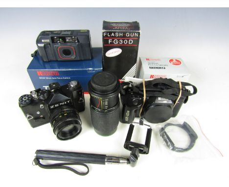 A Zenit camera together with a boxed Ricoh TF-900 camera and lenses etc