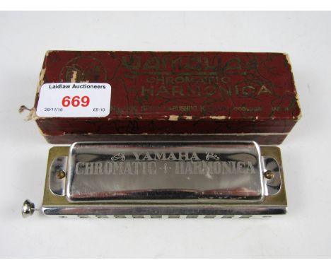 A boxed Yamaha chromatic harmonica