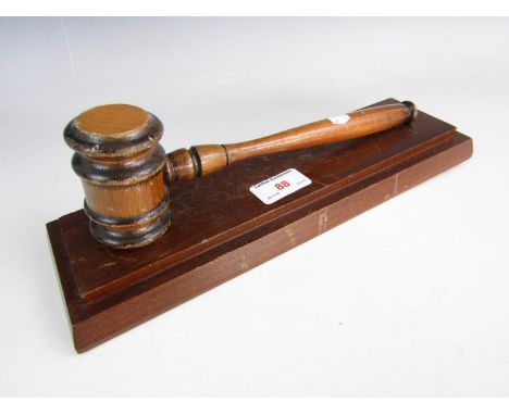 A vintage wooden gavel with stand