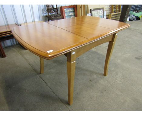 A contemporary light oak kitchen table