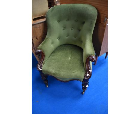 A Victorian scroll arm easy chair having button back