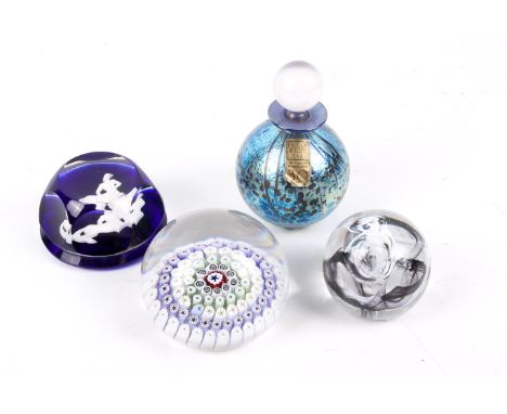 A group of three assorted glass paperweights and a perfume bottle. Including a Baccarat, a Caithness Moon Crystal and a mille