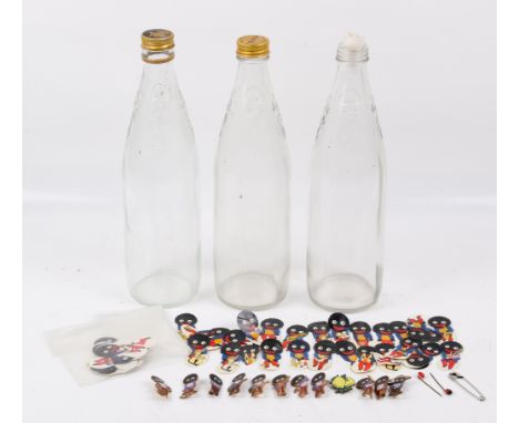 A collection of assorted Robertson's jam character glass drinks bottles, stickers and pin badges. Max. H28cm Notice from the 