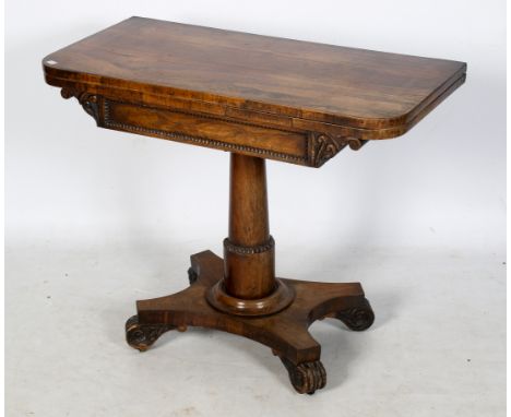 An early Victorian rosewood fold over top card table. With an inset baize playing surface, tapered cylindrical and beaded cen
