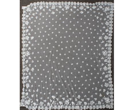 A Victorian Honiton lace veil. Having a machine made button mesh ground covered in a floral motif pattern, the edges featurin