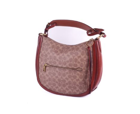 A Coach Sutton Hobo coated canvas tan shoulder bag. Style 38580, constructed in July 2018. Having an adjustable and removable