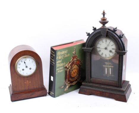 Two mantel clocks and a horological book. Including Junghans mahogany and carved ebonized case timepiece, key and pendulum pr