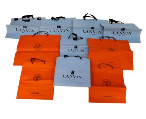A collection of designer shopping bags. Comprising four Hermes bags and seven Lanvin bags, assorted sizes