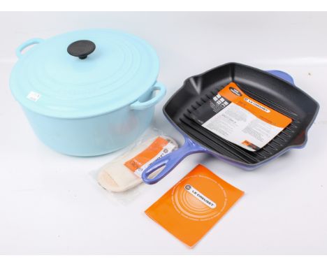 Two Le Creuset enamelled cast iron cooking items. Including a light blue casserole #28 pot and an unused cobalt blue Le Creus