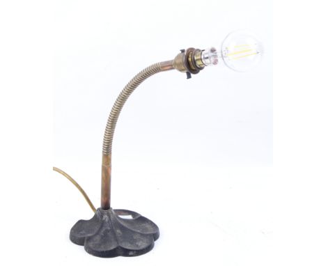 An Art Deco brass gooseneck multi poise desk lamp.  With scalloped case iron base. 