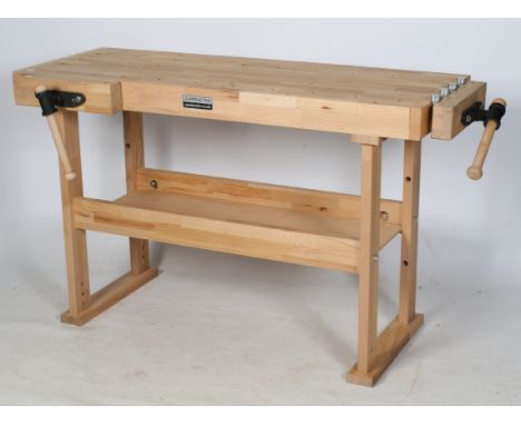 An Axminster carpenter's workshop bench. Consisting of two vices and a shelf beneath. H84cm x W135cm x D51cm