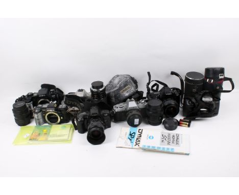 A collection of assorted vintage Minolta film cameras and lenses. Including X-300 with MD 50mm lens, 404si, etc. 