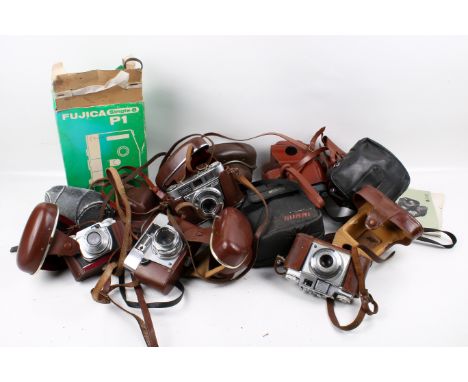 A collection of assorted vintage film cameras. Including a Beirette Junior II, Kodak Retinette IB, etc.