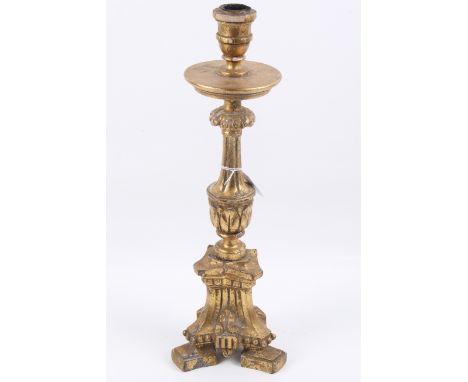 A carved giltwood candlestick. With a fluted column, acanthus leaf decoration raised on a tri-form base. H45cm