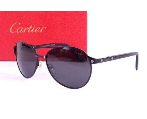 A pair of Cartier Santos Dumont Aviator sunglasses. Complete with the red case and box Condition Report: Overall the sunglass