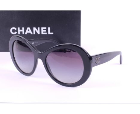 A pair of Chanel black framed sunglasses. No.5372, with blue graduating lens, having the original dust bag, care manual, blac