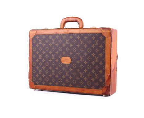 A vintage briefcase in the Louis Vuitton style. Monogram canvas with cow hide trims, handle to the top and a tag to the front