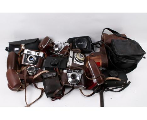 A collection of assorted vintage film cameras. Including a Polaroid Land Camera 1000, etc.