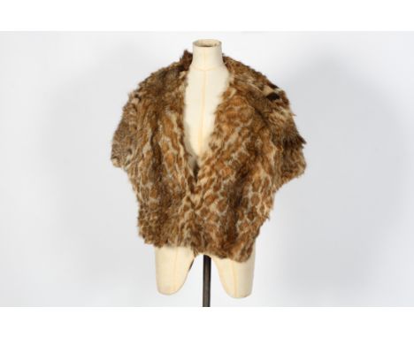 A vintage lynx fur shrug. Lined in brown fabric, W60cm (approx) Condition Report: Some losses and thinning to the interior li