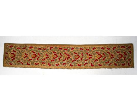 A length of antique Ottoman fabric. Worked in cotton and silk threads with couched flower heads in red and gold surrounded by