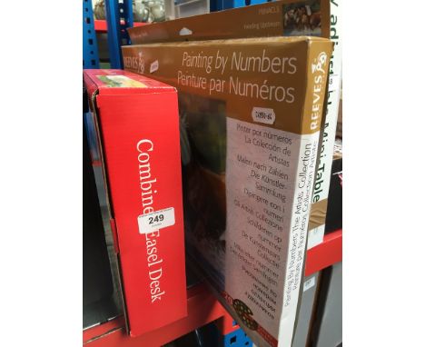 A combined easel desk and a painting by numbers kit. 