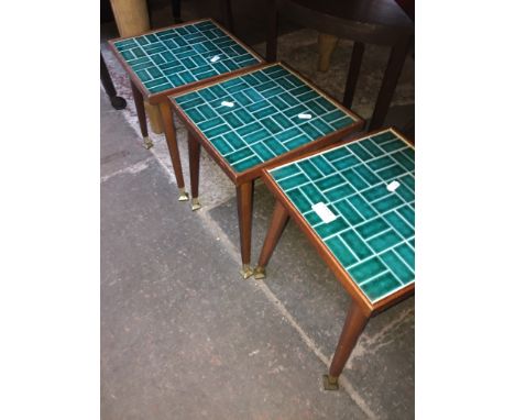 A set of three retro tile top small tables on tapered legs 