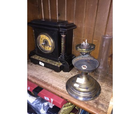 Ebonised wood clock and a brass oil lamp ( damaged ) with glass shade. 